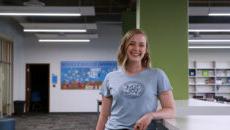 Kaci Jones standing and smiling in the Learning Resource Center